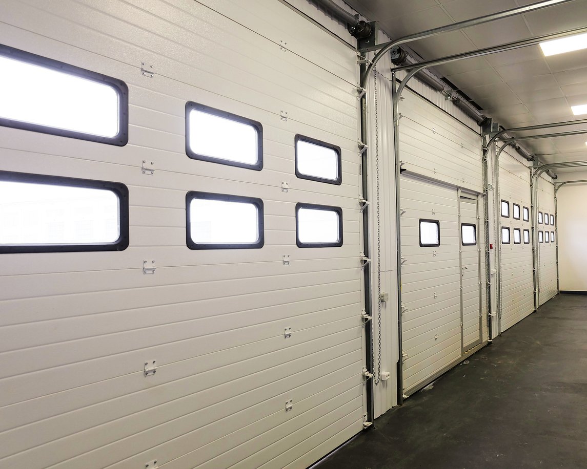 Row of sectional overhead doors and tracks