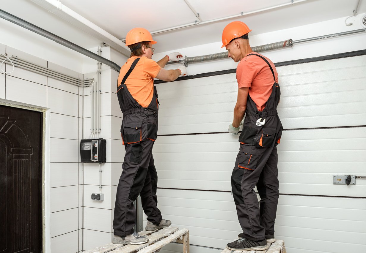 Engineers installing an overhead door