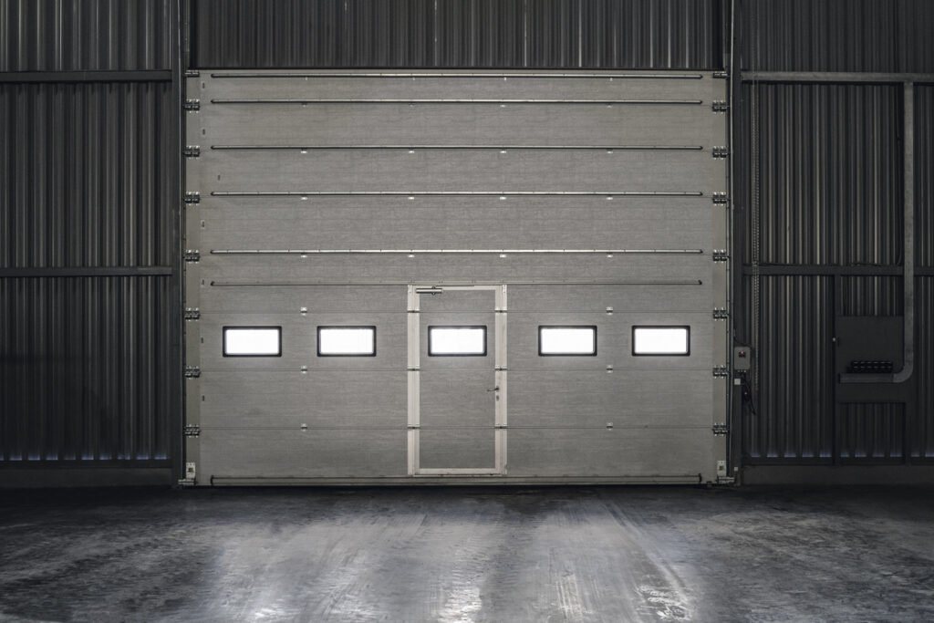 Industrial sectional overhead door with inset personnel door