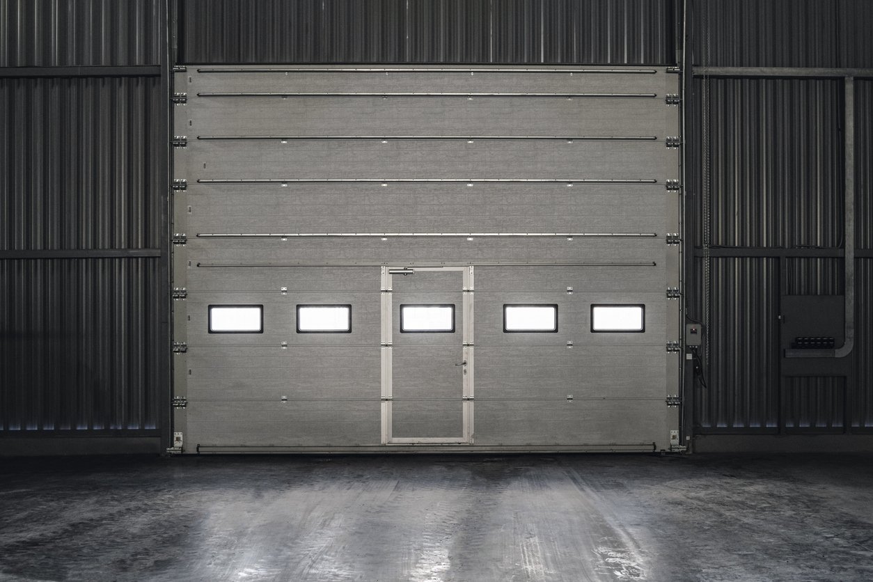 Industrial sectional overhead door with inset personnel door
