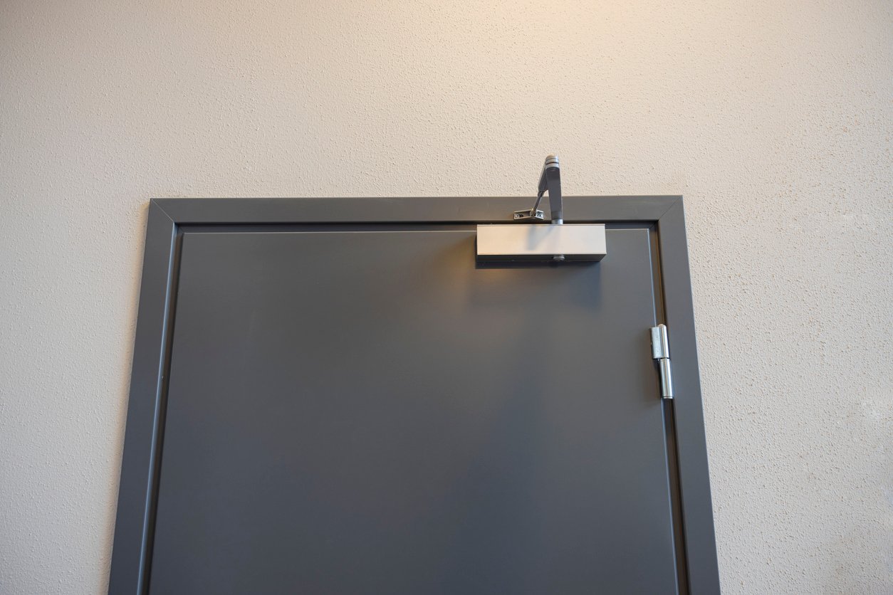 Metal personnel door with closer and hinges