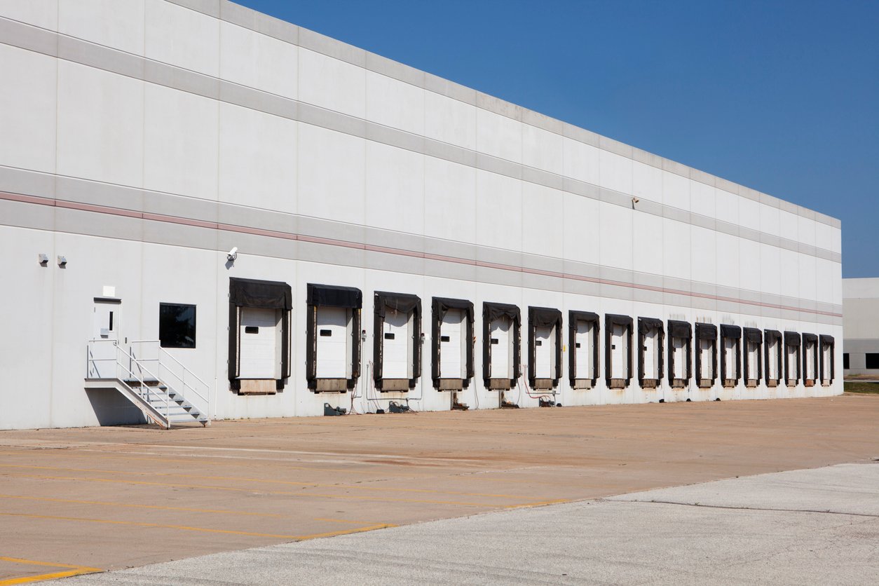Warehouse exterior with a row of loading bays
